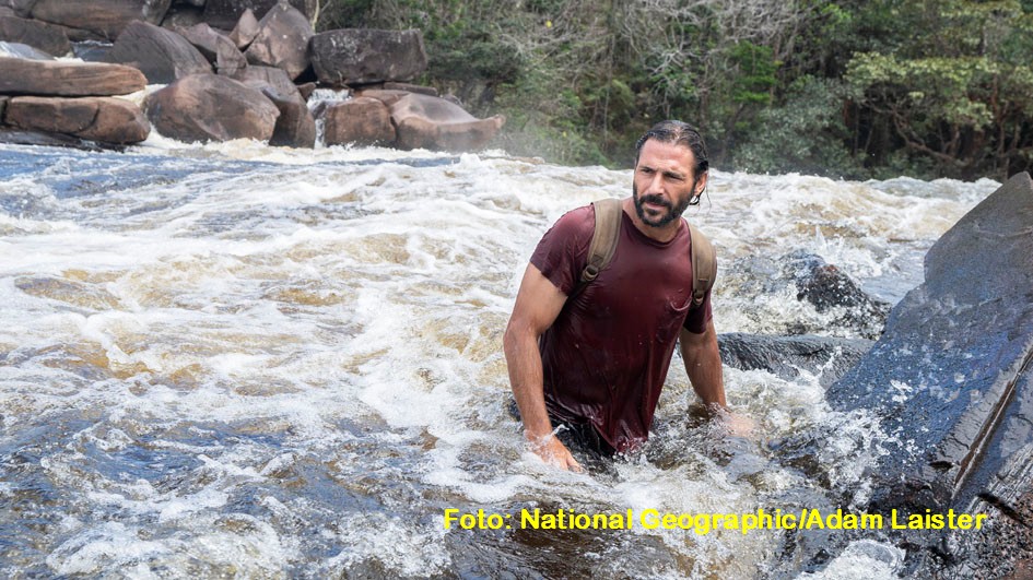 Hazen crossing river through rocky rapids. (National Geographic/Adam Laister)