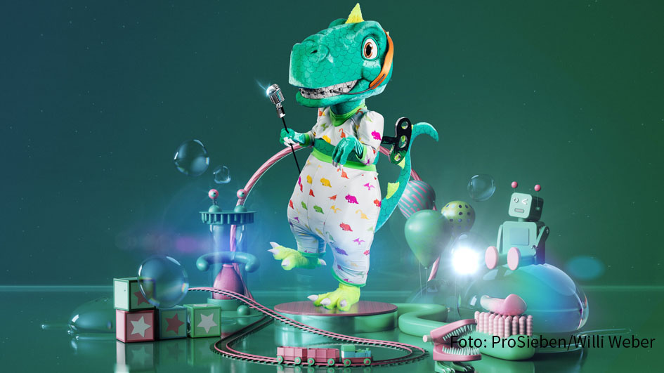 Der Dino mit Zahnspange und Aufzieh-Schlüssel gehörte zu den ersten drei Charakteren der neuen „The Masked Singer“-Staffel, die Ende Januar präsentiert wurden. Ab heute stellt ProSieben täglich um 20:13 Uhr eine der sieben weiteren Masken vor. (Foto: ProSieben/Willi Weber)